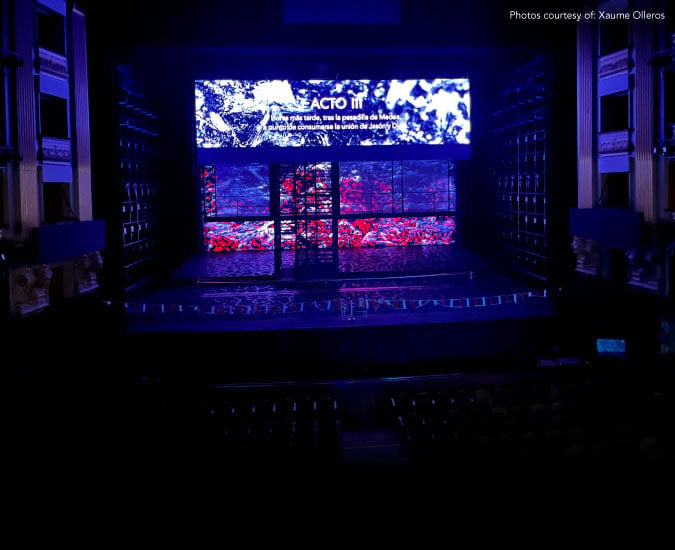 Large screen with blue and white projection on stage in opera theatre