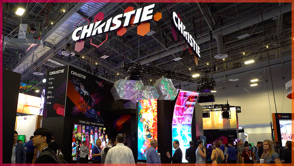 Video thumbnail: a crowd of people exploring the Christie booth, with Christie AV solutions in the background