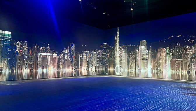 Immersive projection of a stylized cityscape on a panoramic curved screen at the Guangdong Museum of Art