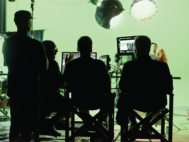 People looking at monitors on a production set. 