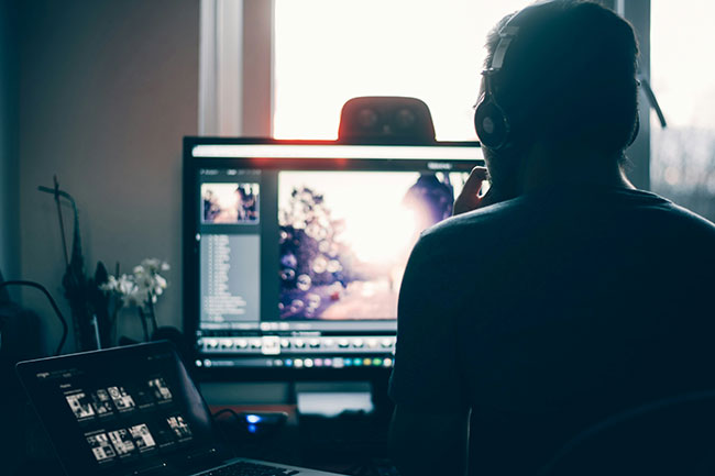 A person looking at a monitor.