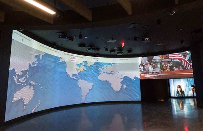 A map of the world is projected onto a large screen.