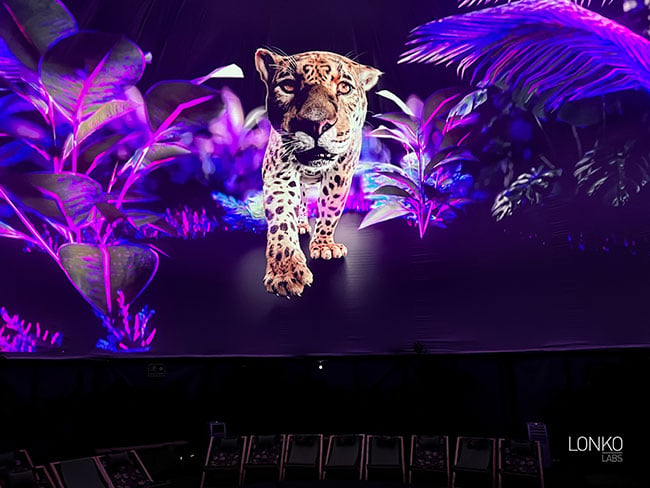 An image of a jaguar is projected onto a domed ceiling. 