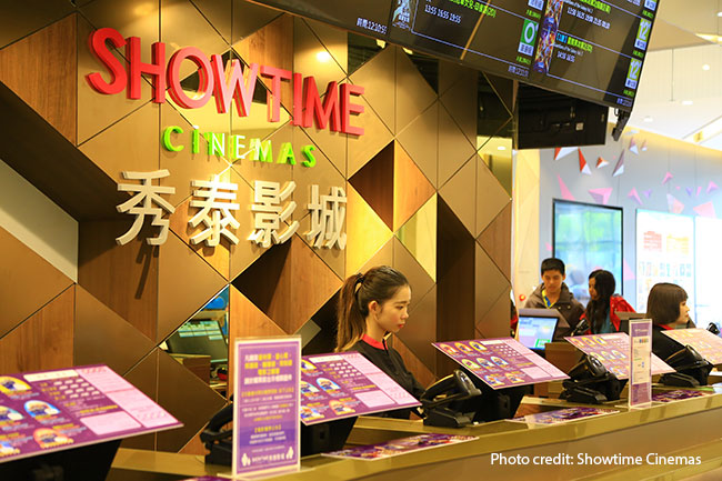 The ticketing area of a cinema complex manned by several employees.