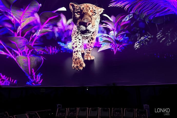 An image of a jaguar is projected onto a large screen.