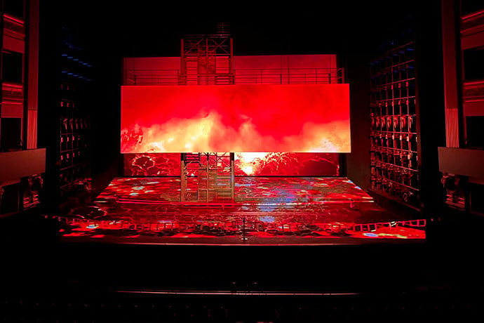 Large screen on stage with red projection in opera theatre